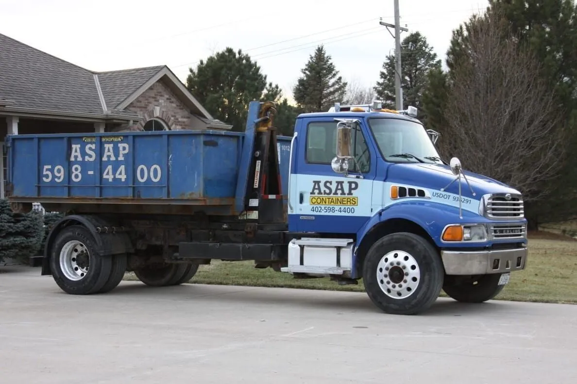 ASAP Containers roll-off dumpster truck delivering a container in Omaha, NE